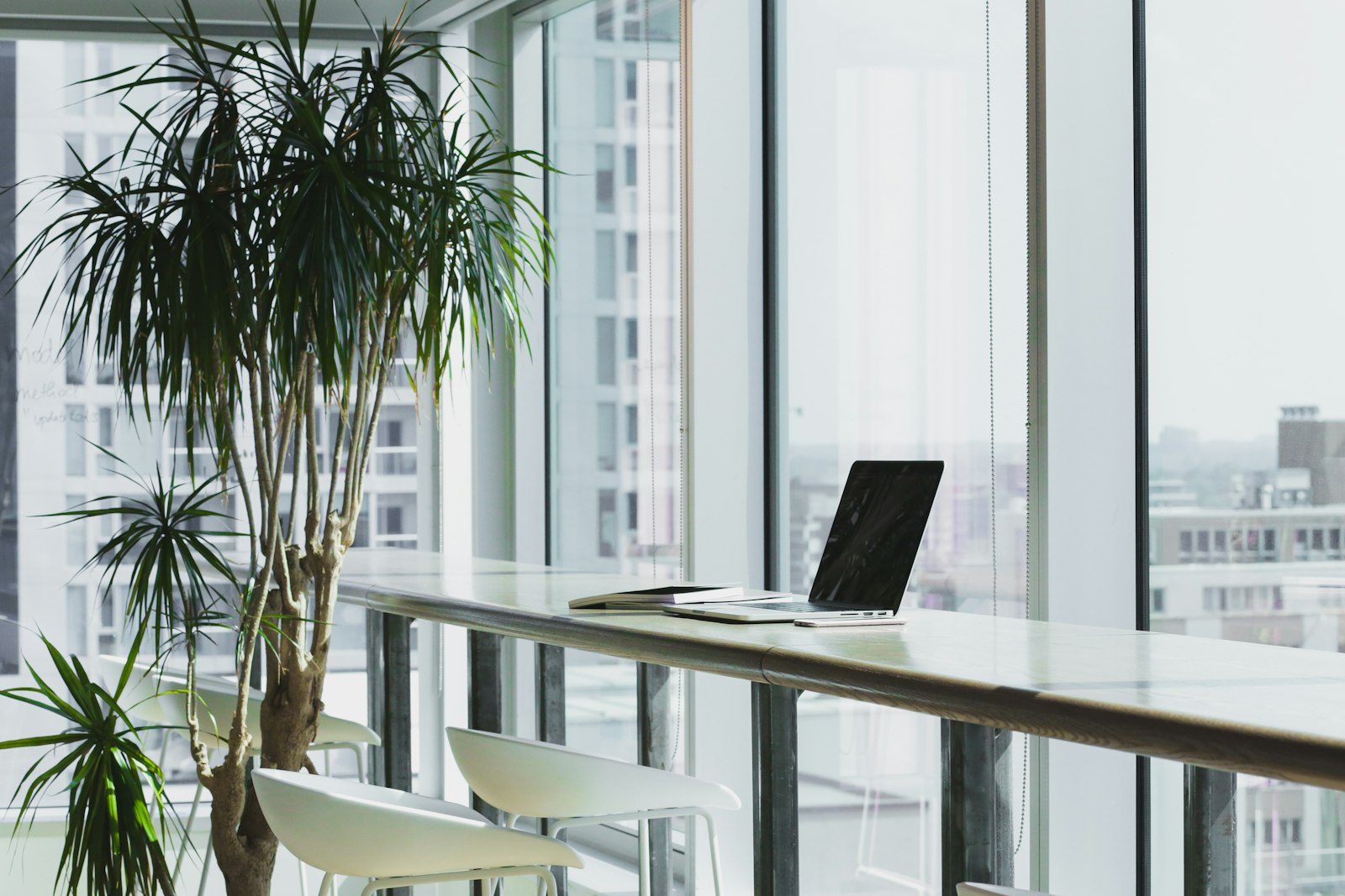 Laptop on an office desk by the window